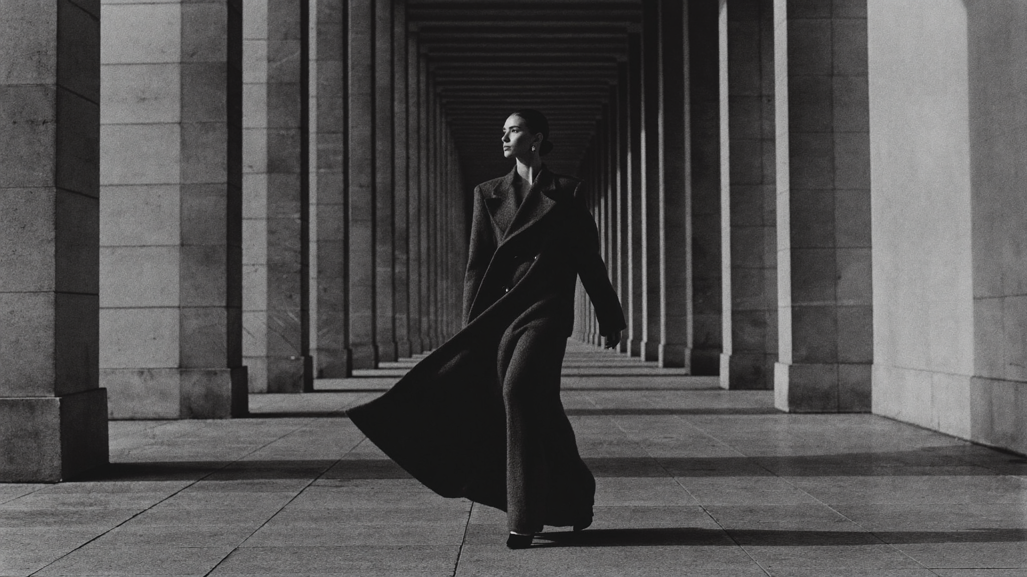Zadren hero v2 — model walking in colonnade